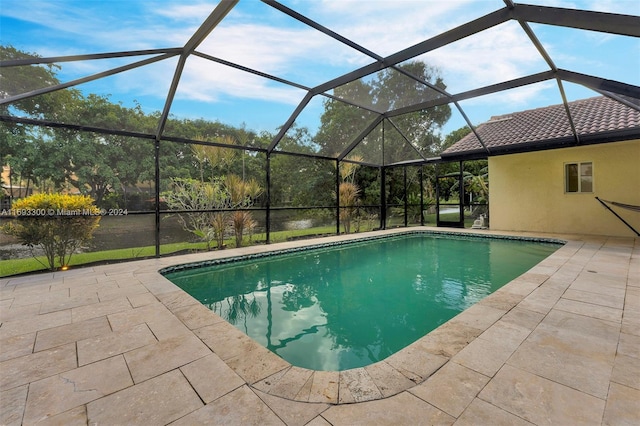 view of swimming pool with glass enclosure and a patio area