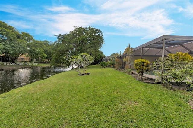 view of yard featuring a water view and a lanai