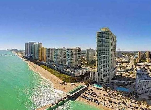 aerial view with a water view and a beach view