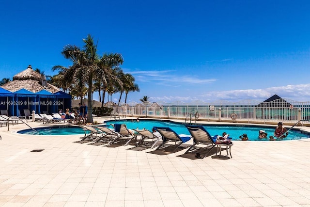 view of pool featuring a mountain view and a patio area