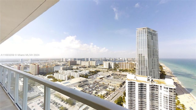 balcony featuring a view of the beach and a water view