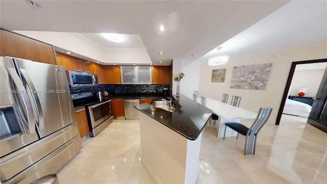 kitchen featuring sink, hanging light fixtures, stainless steel appliances, backsplash, and light tile patterned floors