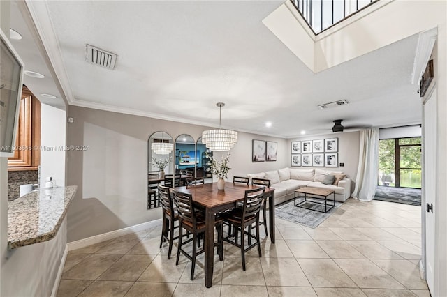 tiled dining area featuring ceiling fan with notable chandelier and crown molding