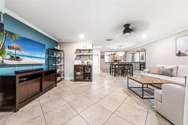 living room featuring ceiling fan, light tile patterned floors, and crown molding