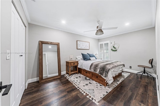 bedroom featuring ceiling fan, ornamental molding, dark wood-type flooring, and a closet