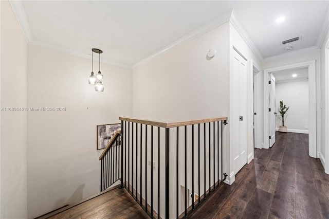 staircase with a chandelier, wood-type flooring, and ornamental molding