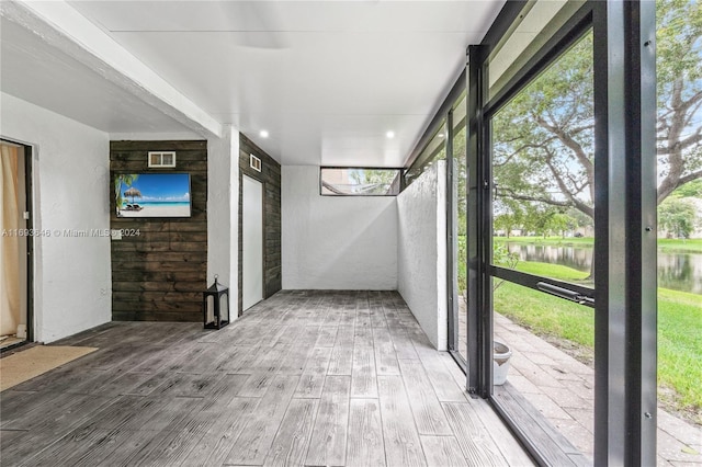 interior space featuring a wealth of natural light and a water view