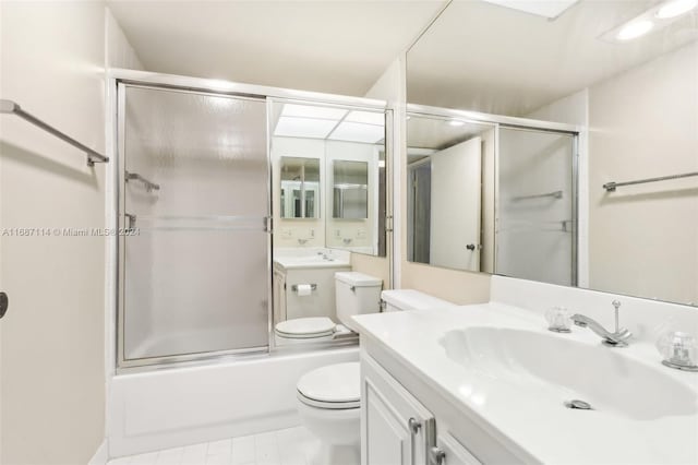 full bathroom with toilet, tile patterned flooring, vanity, and combined bath / shower with glass door