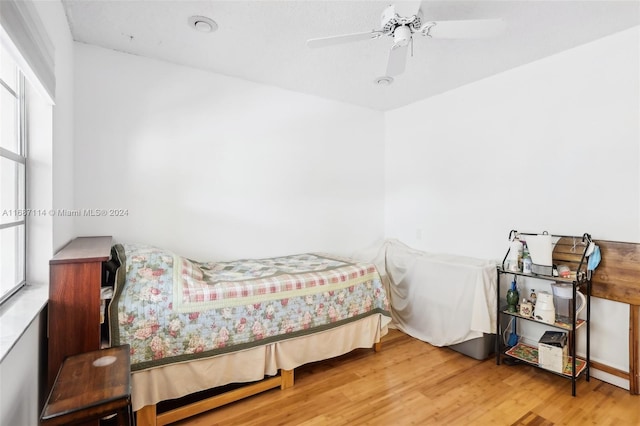 bedroom with wood-type flooring and ceiling fan