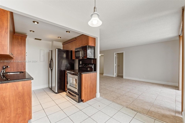 kitchen with sink, electric range, dark stone countertops, light tile patterned floors, and a textured ceiling