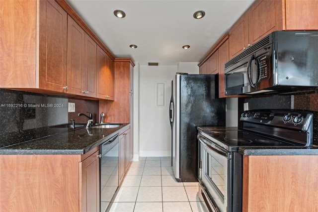 kitchen with backsplash, dark stone counters, black appliances, sink, and light tile patterned floors