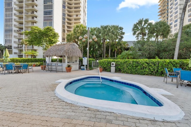 view of swimming pool featuring a gazebo, a community hot tub, and a patio