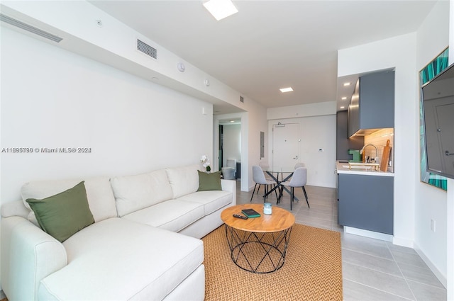 living room with light tile patterned floors and sink