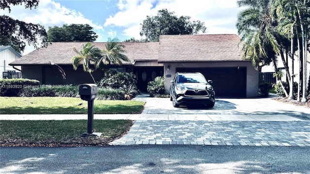 view of front facade with a front yard and a garage