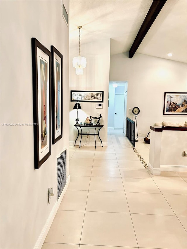 hallway with vaulted ceiling with beams, light tile patterned flooring, and a chandelier