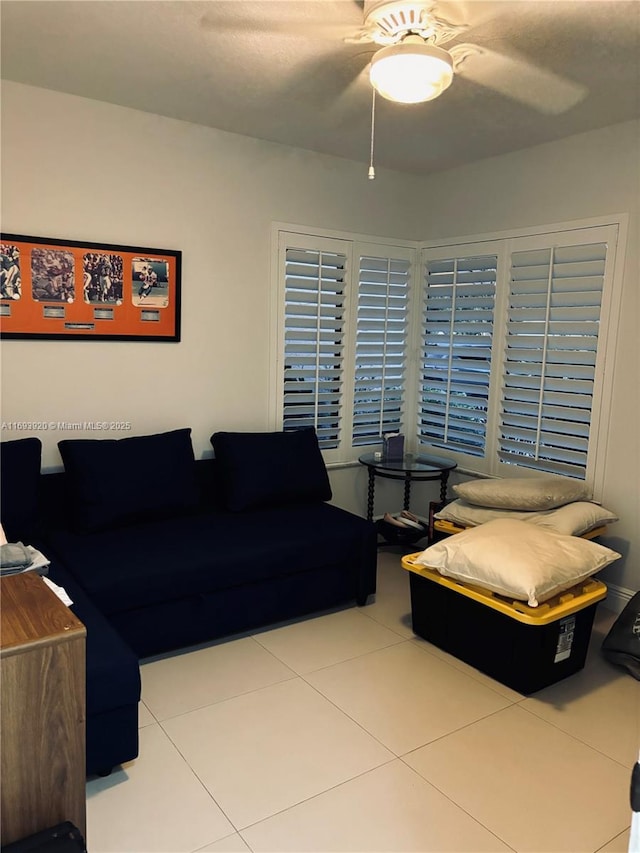 living room featuring ceiling fan and light tile patterned flooring