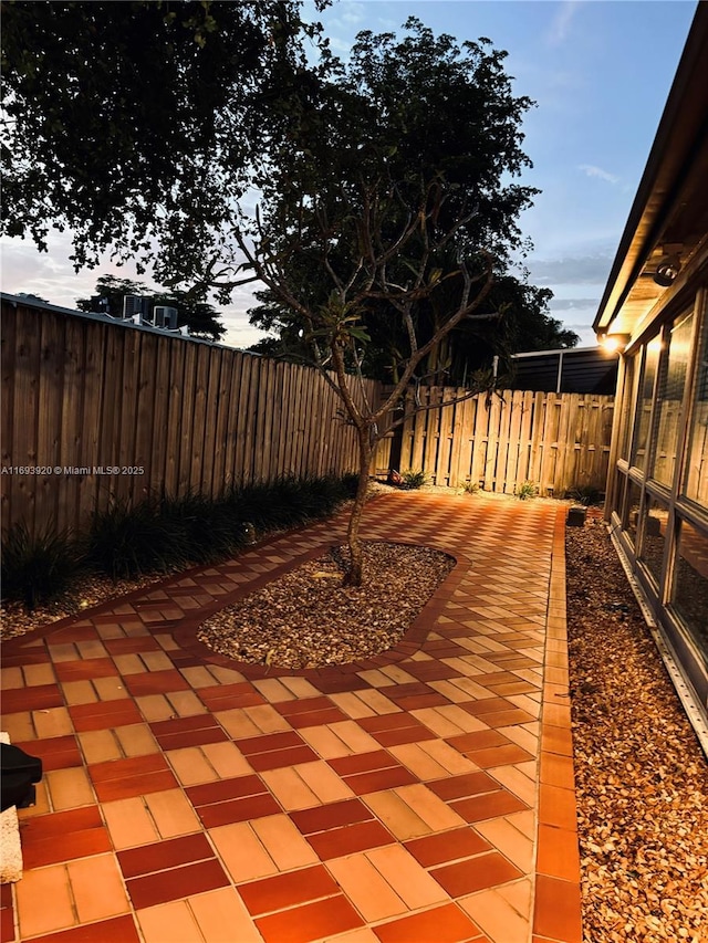 view of patio terrace at dusk