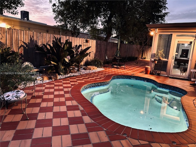 view of pool at dusk