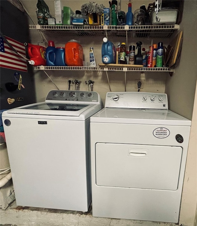 clothes washing area with separate washer and dryer