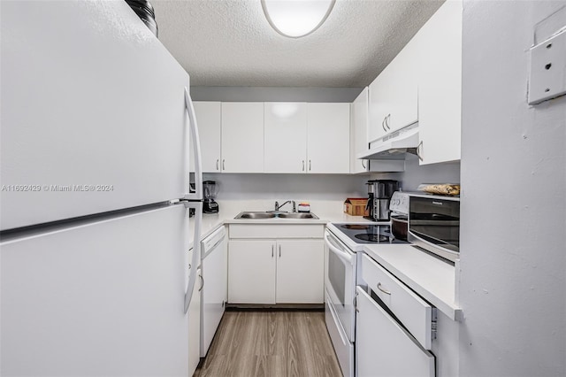 kitchen with white cabinetry, sink, light hardwood / wood-style flooring, a textured ceiling, and white appliances