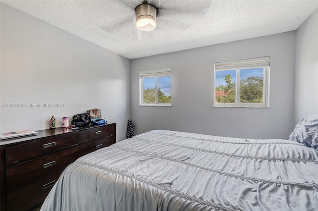 bedroom featuring a textured ceiling and ceiling fan