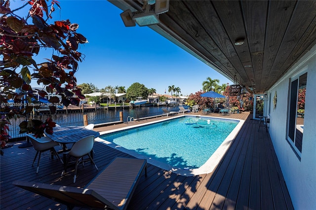 view of swimming pool featuring a deck with water view