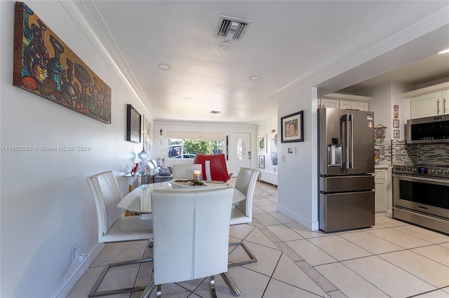 tiled dining area featuring crown molding