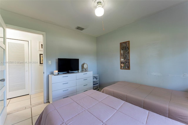 bedroom featuring a closet and light tile patterned floors