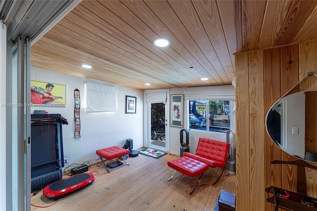 living area featuring wood ceiling and wood-type flooring