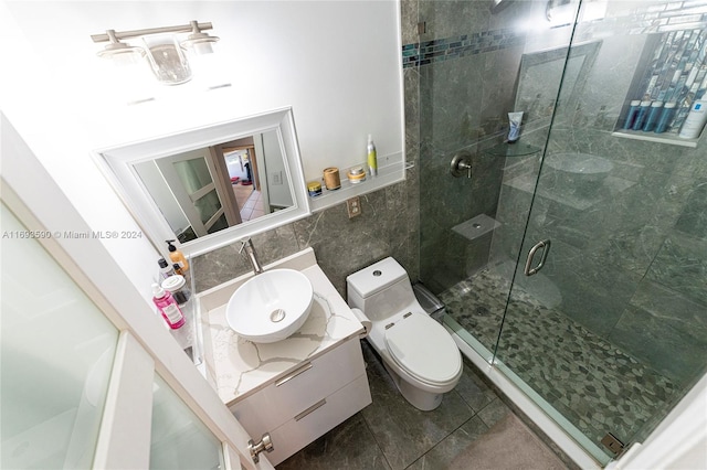 bathroom featuring vanity, tile patterned floors, decorative backsplash, toilet, and an enclosed shower