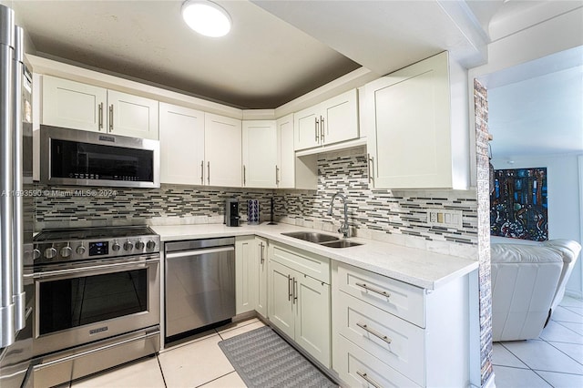 kitchen featuring light tile patterned flooring, sink, white cabinetry, and stainless steel appliances