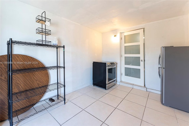 kitchen with light tile patterned floors and appliances with stainless steel finishes