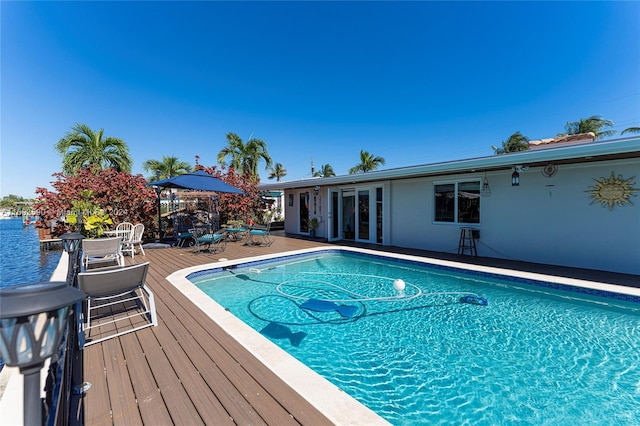 view of swimming pool with a deck