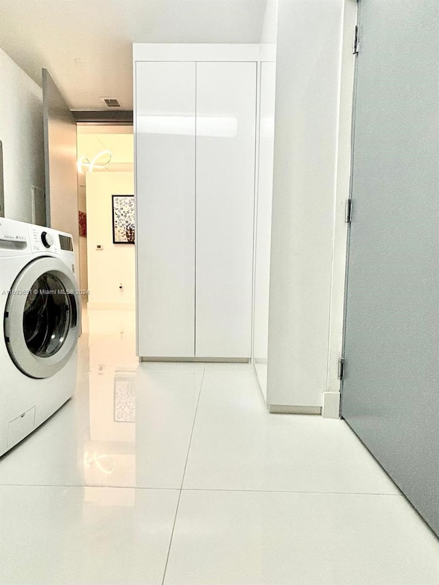 washroom featuring washer / dryer and light tile patterned floors