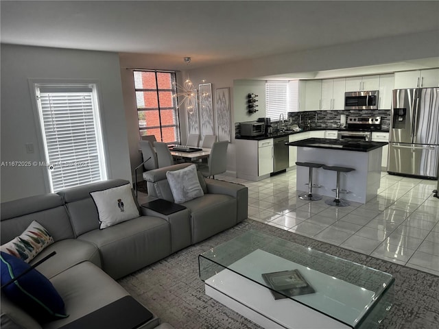 tiled living room featuring an inviting chandelier and sink