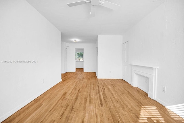 unfurnished living room featuring ceiling fan and light hardwood / wood-style floors