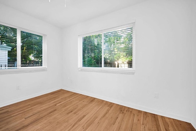 unfurnished room with hardwood / wood-style floors