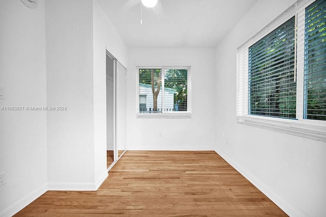 empty room with a healthy amount of sunlight and light hardwood / wood-style flooring