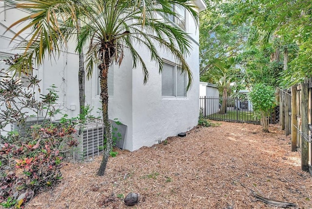 view of side of home with central air condition unit