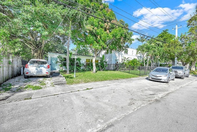 view of parking featuring a yard