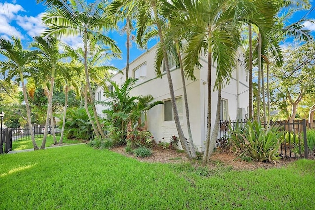 view of side of property with a yard