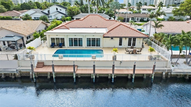 rear view of property featuring a patio and a water view