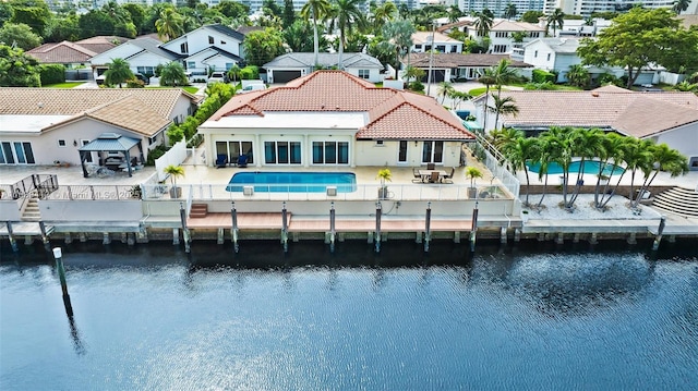 rear view of house featuring a water view and a patio