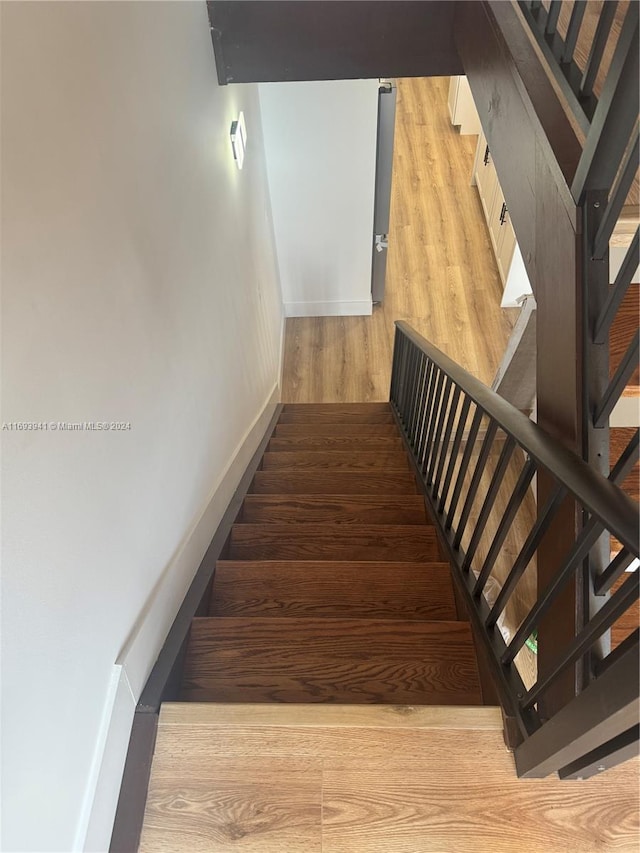 staircase featuring hardwood / wood-style flooring