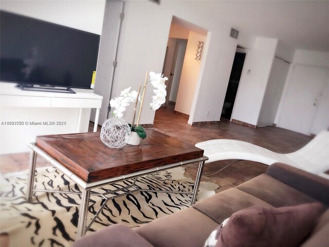 801 Three Islands Blvd Unit 411, Hallandale Beach, FL 33009 - living area featuring baseboards and wood finished floors