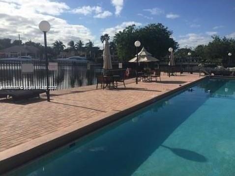 801 Three Islands Blvd Unit 411, Hallandale Beach, FL 33009 - view of pool with a patio and fence
