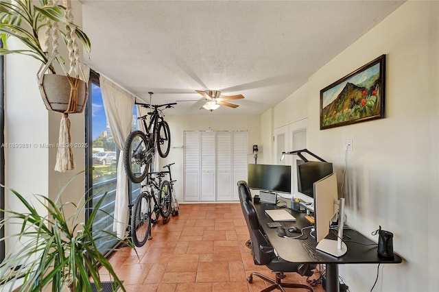 office space with a textured ceiling and ceiling fan