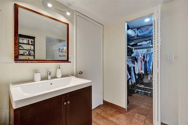 bathroom featuring a textured ceiling and vanity