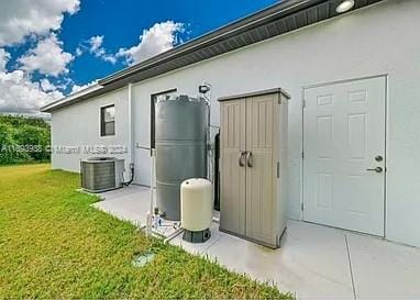 exterior space with a yard and central air condition unit