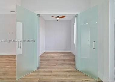 corridor with light hardwood / wood-style flooring